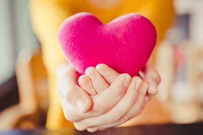 woman holding a heart shaped object